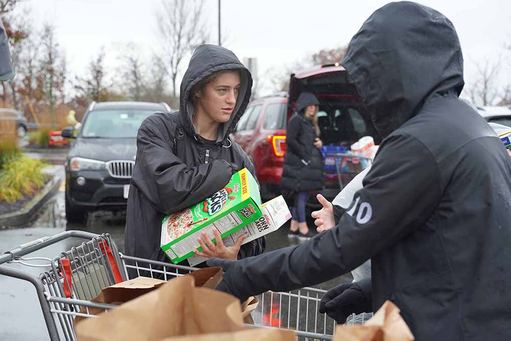 Bella Goulart, 17, of Gloucester volunteers at Market Basket in Gloucester at Saturday’s Thanksgiving Food Drive. (Photo Courtesy of The Open Door)