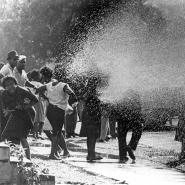 Children's Crusade protesters are sprayed by firehoses.