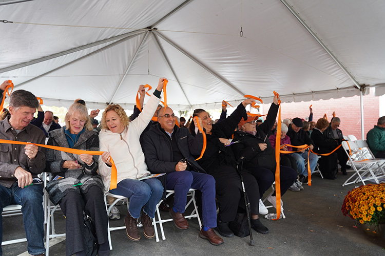 Gloucester Mayor Greg Verga, center, smiles as he waves orange ribbon, along with his wife Kellie, on left, and to his right former Mayor Sefatia Romeo Theken and Rep. Ann-Margaret Ferrante.  (Photo Courtesy of The Open Door) 